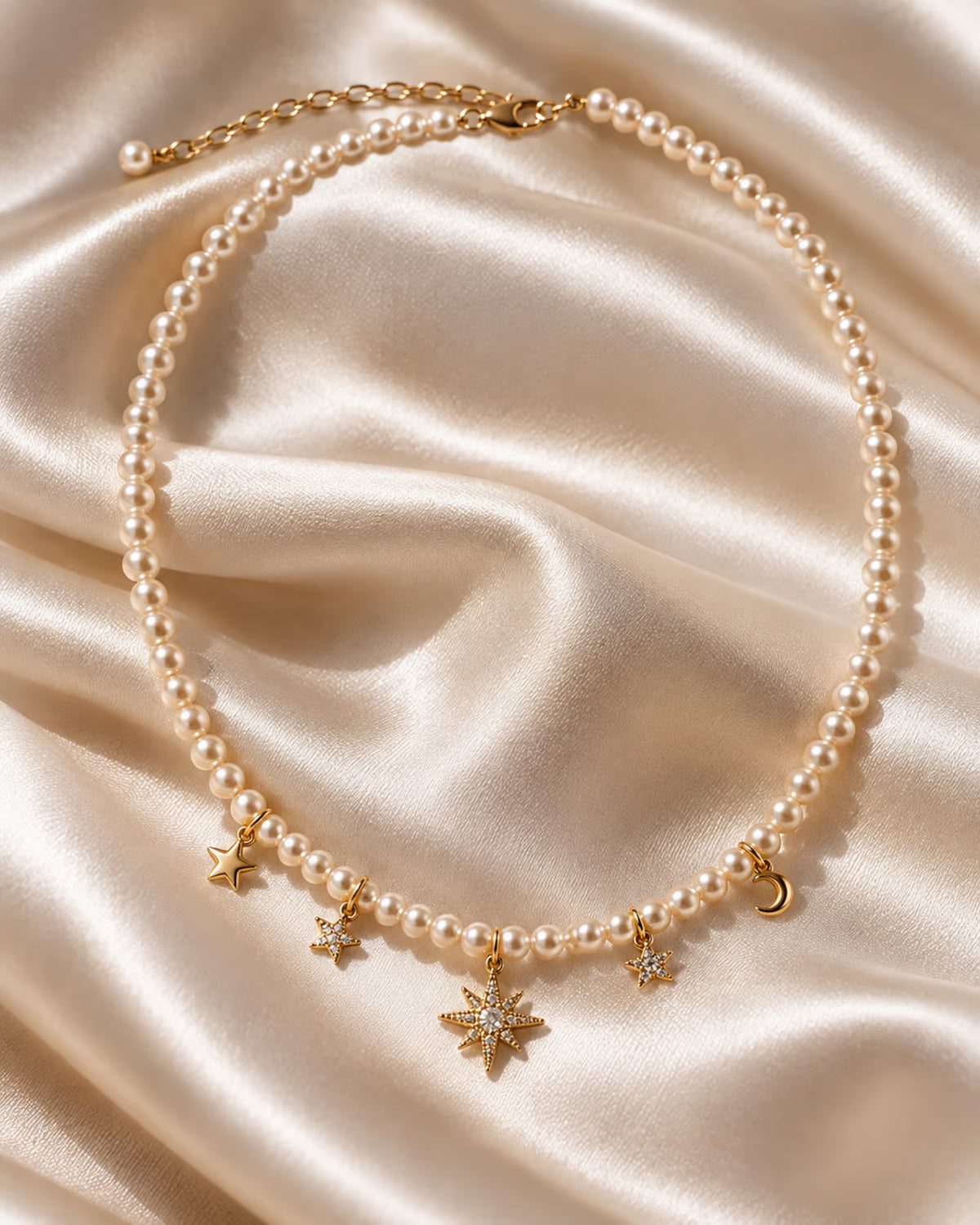 Tie Shop Moon & Star Necklace pearl beaded choker with gold celestial charms on silk background. سلاسل نسائية من تاى شوب مون آند ستار نيكليس، عقد من اللؤلؤ مزين بدلايات ذهبية على شكل هلال ونجمة مرصعة بالفصوص، مجوهرات وإكسسوارات أنيقة.