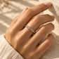 Tie Shop silver ring with baguette and round cz crystals on model hand. خواتم نسائية من تاي شوب خاتم فضي مرصع بأحجار الزركون المستطيلة والدائرية، مجوهرات وإكسسوارات أنيقة.