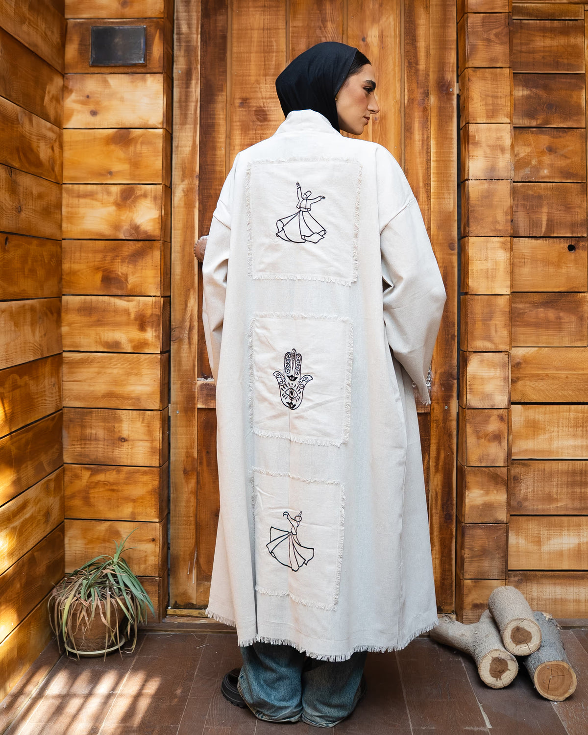 Tie Shop Remal Cardigan back view with Whirling Dervish and Hamsa Hand embroidery. كارديجان رمال أوف وايت بتطريز الدراويش وكف الفاطمية من تاي شوب.