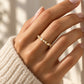 Tie Shop gold ring with multi-shape cz stones on model hand. خواتم نسائية من تاي شوب خاتم ذهبي مرصع بأحجار الزركون متعددة الأشكال، مجوهرات وإكسسوارات أنيقة.
