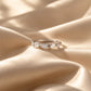 Tie Shop silver ring with multi-cut cz crystals on silk background. خواتم نسائية من تاي شوب خاتم فضي مرصع بأحجار الزركون بأشكال هندسية متنوعة، مجوهرات وإكسسوارات أنيقة.