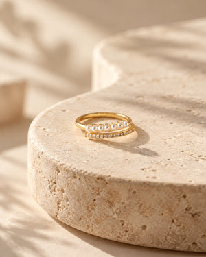 Tie Shop gold pearl and pave zircon double ring display. خواتم نسائية من تاي شوب خاتم ذهبي بصف لؤلؤ وصف زركون براق، مجوهرات وإكسسوارات أنيقة.
