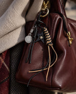 Tie Shop Black Star & Smile Face Leather Bag Charm. تعليقة حقيبة نسائية من تاي شوب بنجمة وسلسلة وجه مبتسم، إكسسوار أنيق للشنط.