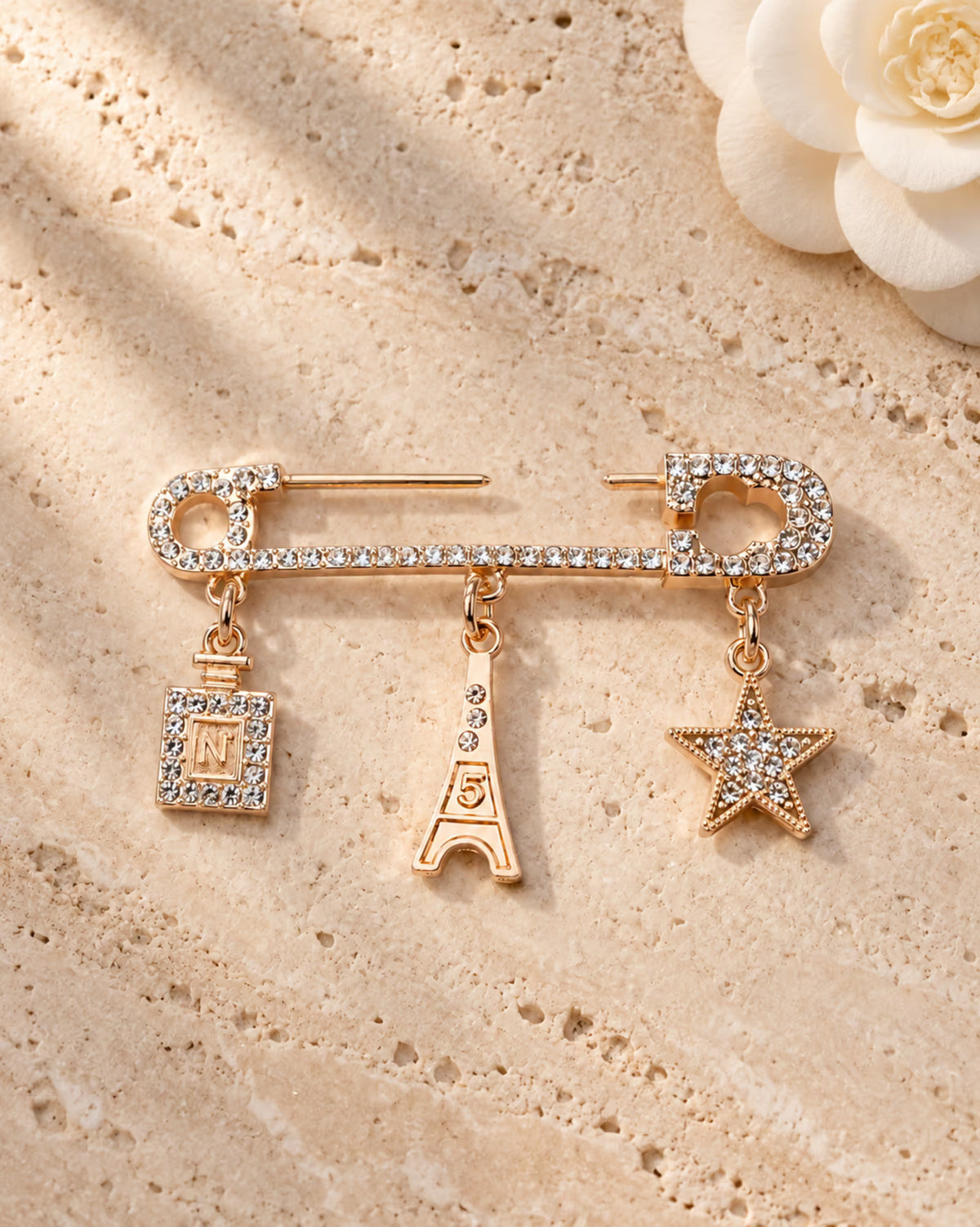 Zia Paris Charm Pin women brooch by Tie Shop. بروش ذهبي مرصع بالكريستال بتصميم عصري راقي.