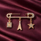 Gold Zia Charm Pin brooch by Tie Shop. تفاصيل بروش نسائي فاخر مرصع بالكريستال بدلايات أنيقة للمناسبات.