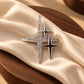Close-up of Tie Shop Silver Sparkling Star Crystal Brooch on beige satin cloth and wooden plate, a stylish pin for abayas and hijabs. صورة مقربة لـ بروش النجوم الفضي المرصع بالكريستال من تاي شوب على قماش حرير بيج وطبق خشبي، دبوس أنيق للعبايات والحجاب.