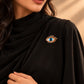 Model wearing a black formal dress accessorized with Tie Shop Gold Blue Eye Crystal Brooch, a stylish pin for abayas and dresses. موديل ترتدي فستان أسود أنيق مزين بـ بروش العين الزرقاء الذهبي من تاي شوب، دبوس عصري للعبايات والفساتين.