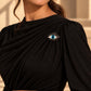 Model wearing a black elegant dress styled with Tie Shop Silver Blue Eye Crystal Brooch on the shoulder, a statement accessory. موديل ترتدي فستان سهرة أسود أنيق مزين بـ بروش العين الزرقاء الفضي من تاي شوب على الكتف، اكسسوار عالي الجودة.